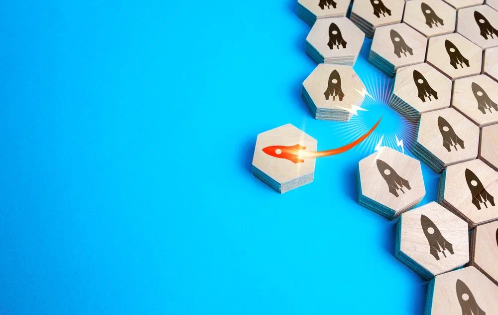 One rocket breaking ahead of a uniform grid of hexagon blocks - representing a strategic competitive advantage